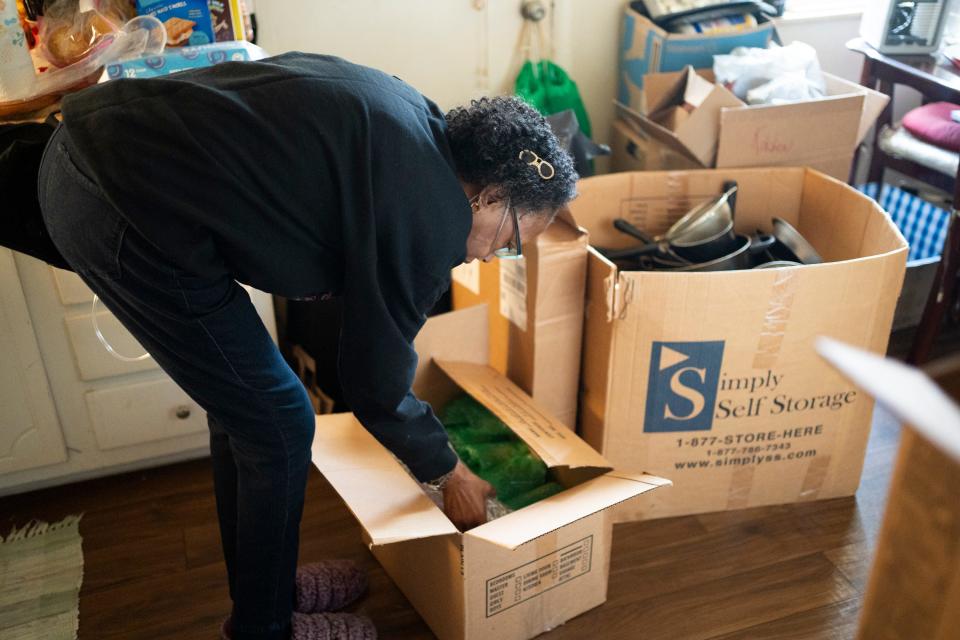 Cynthia Wray, who has sickle cell anemia, slowly packs up her apartment Monday at Colonial Village Apartments in Columbus, where she has lived there for 12 years. The complex's management company, Capstone Real Estate Services, has given all residents until Dec. 31 to find new housing so repairs can be made at the apartments.