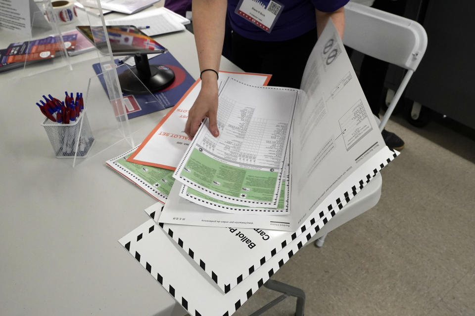 FILE - A poll worker assembles a ballot at Frank McCourt High School in New York's party primaries, Tuesday, June 22, 2021, in New York. New York City, long a beacon for immigrants, is on the cusp of becoming the largest place in the U.S. to give noncitizens the right to vote. Legally documented, voting-age noncitizens, who comprise nearly one in 10 of the city's 8.8 million inhabitants, would be allowed to cast votes in elections to pick the mayor, City Council members and other municipal officeholders under a bill nearing approval. (AP Photo/Richard Drew)