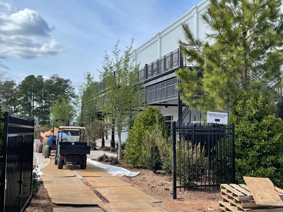 The former Electrolux building in Augusta's National Hills Shopping Center is shown as it was in 2019, and as it is while construction is completed on Map & Flag, the Augusta National Golf Club's new hospitality venue.