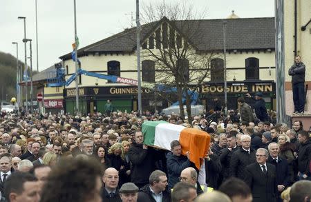 The coffin of Martin McGuinness is carried through crowded streets during his funeral in Londonderry, Northern Ireland, March 23, 2017. REUTERS/Clodagh Kilcoyne