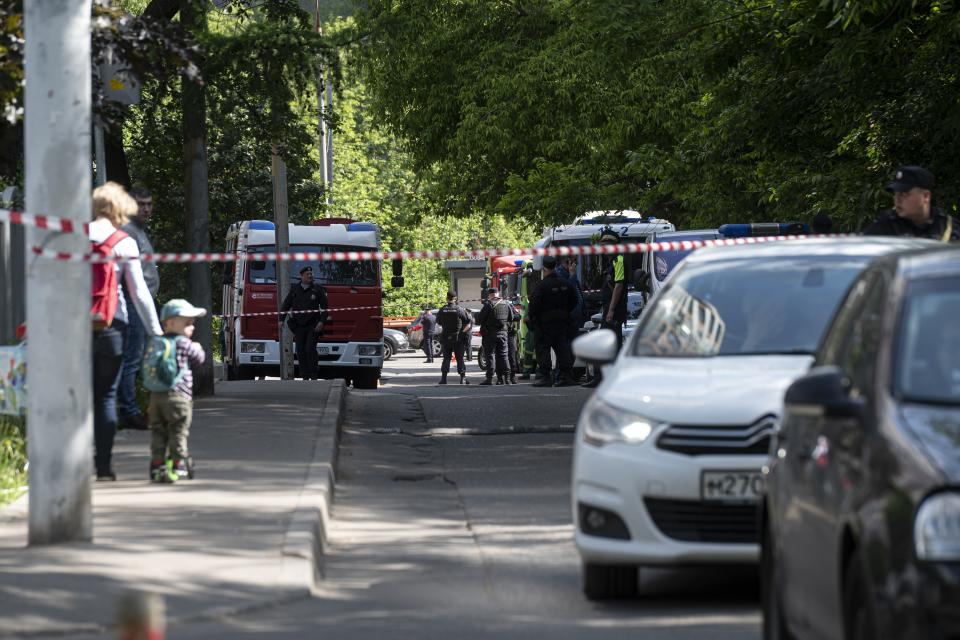 Police block an area where investigators collect parts of a Ukrainian drone which reportedly damaged an apartment building in Moscow, Russia, Tuesday, May 30, 2023. In Moscow, residents reported hearing explosions and Mayor Sergei Sobyanin later confirmed there had been a drone attack that he said caused "insignificant" damage. (AP Photo)