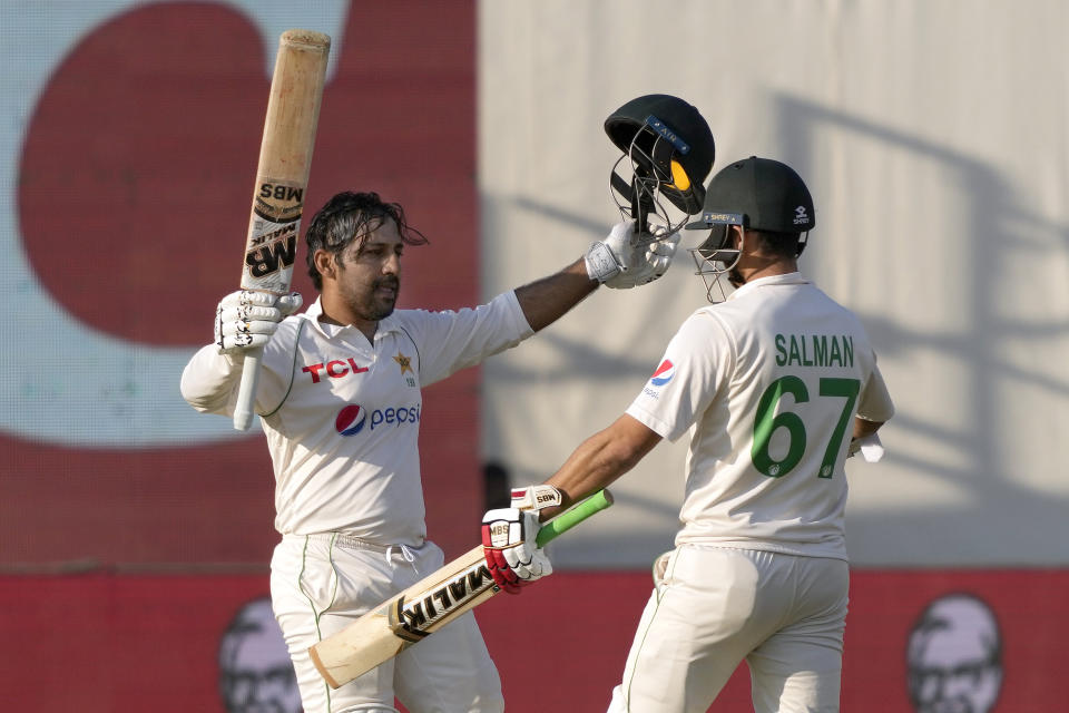 Pakistan's Sarfraz Ahmed, left, celebrates with teammate Agha Salman after scoring century during the fifth day of the second test cricket match between Pakistan and New Zealand, in Karachi, Pakistan, Friday, Jan. 6, 2023. (AP Photo/Fareed Khan)