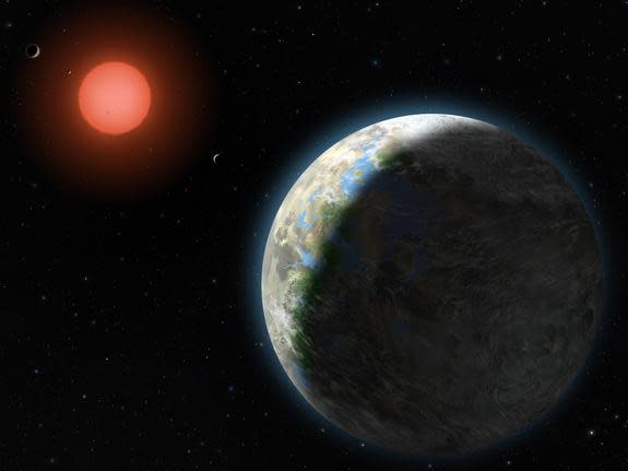 View of the possible inner planets of the Gliese 581 system along with their star, a red dwarf.