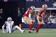 Dallas Cowboys wide receiver Ced Wilson (1) looks on as San Francisco 49ers middle linebacker Fred Warner (54) and defensive back K'Waun Williams (24) celebrate Williams' interception of a pass intended for Wilson in the second half of an NFL wild-card playoff football game in Arlington, Texas, Sunday, Jan. 16, 2022. (AP Photo/Ron Jenkins)