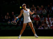 Samantha Stosur of Australia plays a forehand during the Ladies' Singles third round match against Sabine Lisicki of Germany on day six of the Wimbledon Lawn Tennis Championships at the All England Lawn Tennis and Croquet Club on June 29, 2013 in London, England.