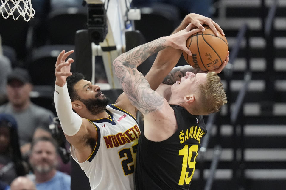 Denver Nuggets guard Jamal Murray (27) defends against Utah Jazz forward Luka Samanic (19) during the first half of an NBA basketball game Tuesday, April 9, 2024, in Salt Lake City. (AP Photo/Rick Bowmer)