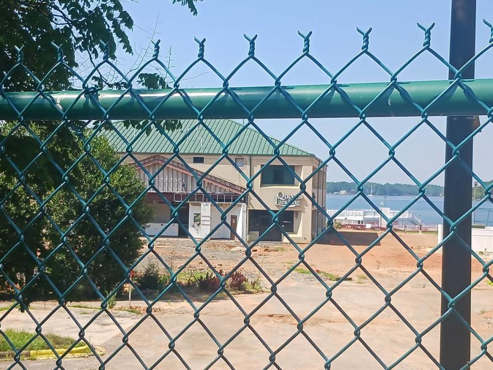 Fencing bars entry to the closed Queens Landing entertainment complex on Lake Norman in Mooresville Tuesday, June 27, 2023.   