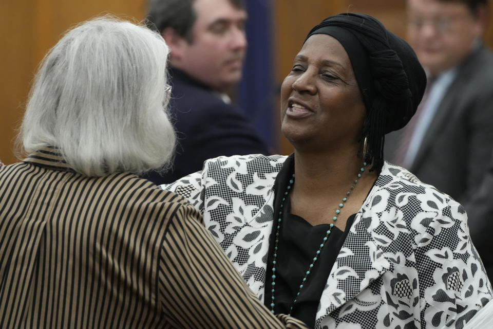 Sabreen Sharrief, right, reaches out to hug fellow plaintiff Dorothy Triplett, left, after testifying at a hearing, Wednesday, May 10, 2023, in Hinds County Chancery Court in Jackson, Miss., where a judge heard arguments about a Mississippi law that would create a court system with judges who would be appointed rather than elected. (AP Photo/Rogelio V. Solis)