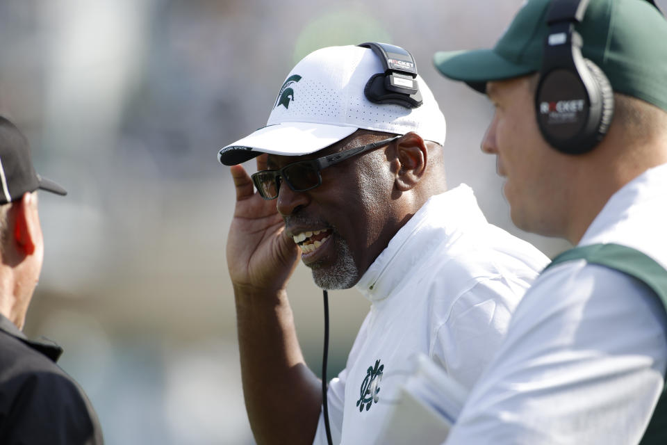 Michigan State acting head coach Harlon Barnett talks to an official during the first half of an NCAA college football game against Maryland, Saturday, Sept. 23, 2023, in East Lansing, Mich. (AP Photo/Al Goldis)