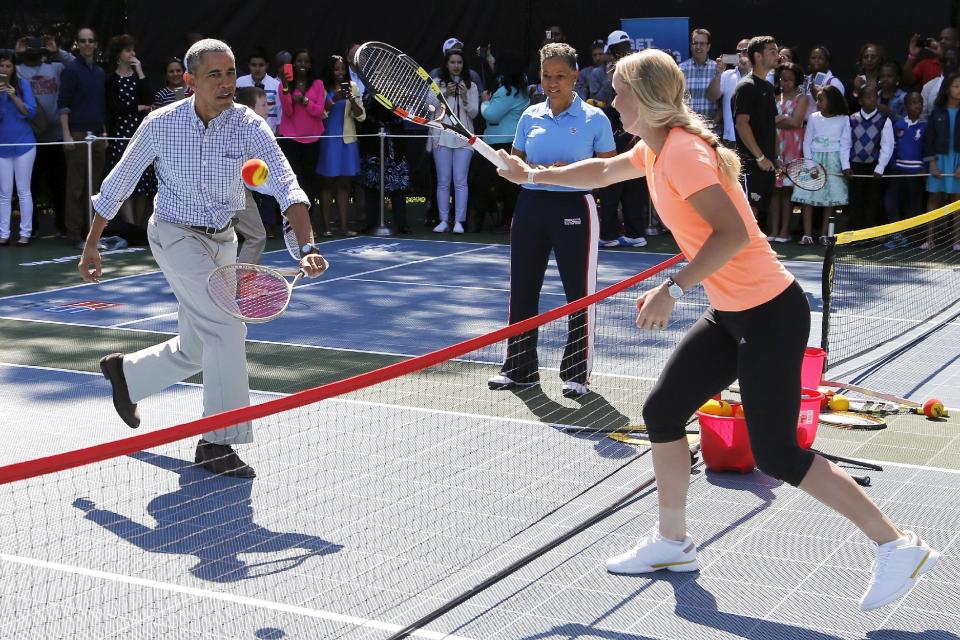 U.S. President Barack Obama plays tennis with tennis player Caroline Wozniacki, one of the activities at the annual Easter Egg Roll at the White House in Washington April 6, 2015. REUTERS/Jonathan Ernst