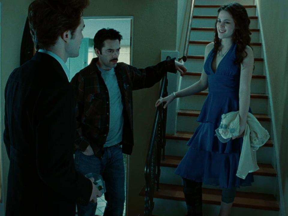 Robert Pattinson as Edward, Billy Burke as Charlie, and Kristen Stewart as Bella in "Twilight."