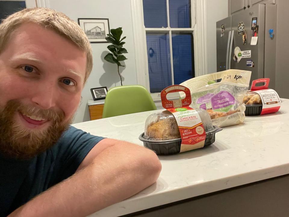 The writer poses with all three chickens laid out on kitchen counter