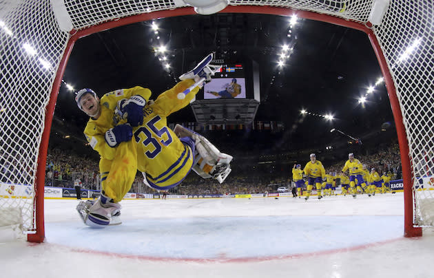 Sweden’s Henrik Lundqvist is hugged by his teammate William Nylander after winning the Ice Hockey World Championships gold medal match between Canada and Sweden in the LANXESS arena in Cologne, Germany, Sunday, May 21, 2017. (Andre Ringuette/Pool Photo via AP)