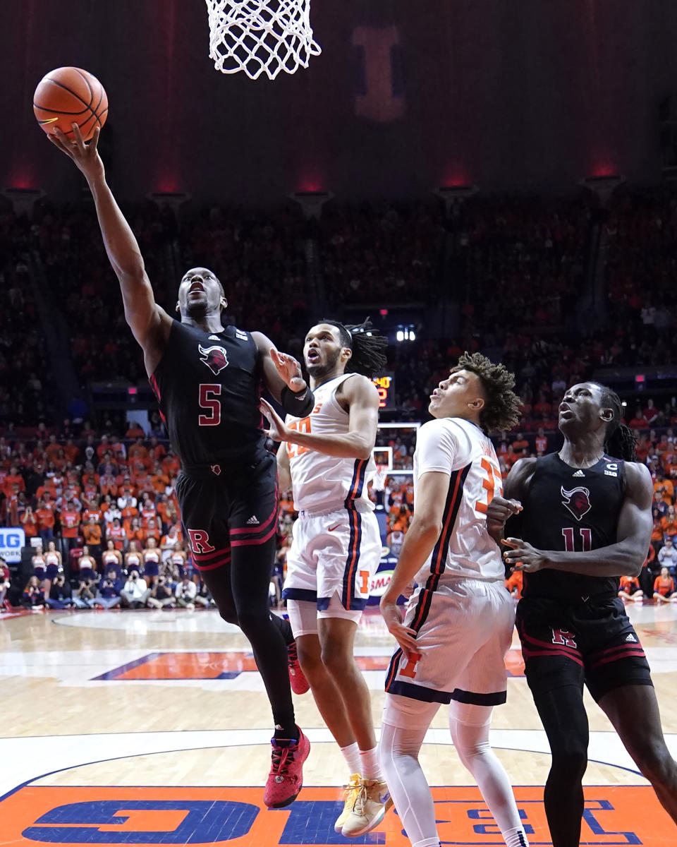 Rutgers' Aundre Hyatt (5) drives to the basket past Illinois' Ty Rodgers as Coleman Hawkins (33) and Clifford Omoruyi (11) watch during the first half of an NCAA college basketball game Sunday, Jan. 21, 2024, in Champaign, Ill. (AP Photo/Charles Rex Arbogast)