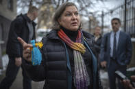 Under Secretary of State for Political Affairs Victoria Nuland holds a doll made by children who have been driven from their homes in the country's eastern and southern regions because of the war, as she talks to the media in Kyiv, Ukraine, Saturday, Dec. 3, 2022. (AP Photo/Roman Gritsyna)