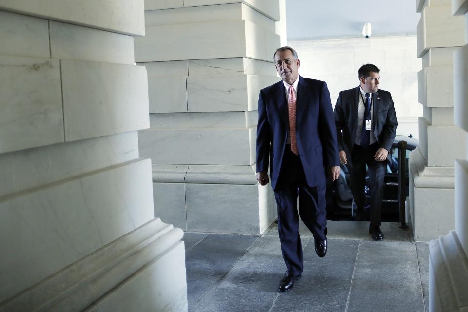 Boehner arrives with his security detail at the U.S. Capitol in Washington