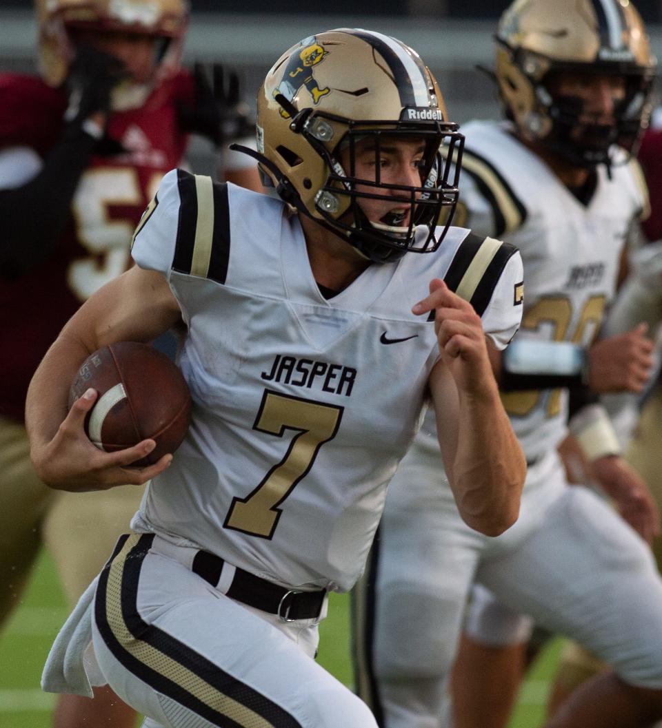 Jasper's Grant Young (7) runs for a first down as the Mater Dei Wildcats play the Jasper Wildcats at the Reitz Bowl in Evansville, Ind., Friday evening, Sept. 17, 2021.