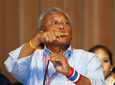 Anti-government protest leader Suthep Thaugsuban gestures during a meeting with his supporters at the Government House in Bangkok May 17, 2014. REUTERS/Chaiwat Subprasom