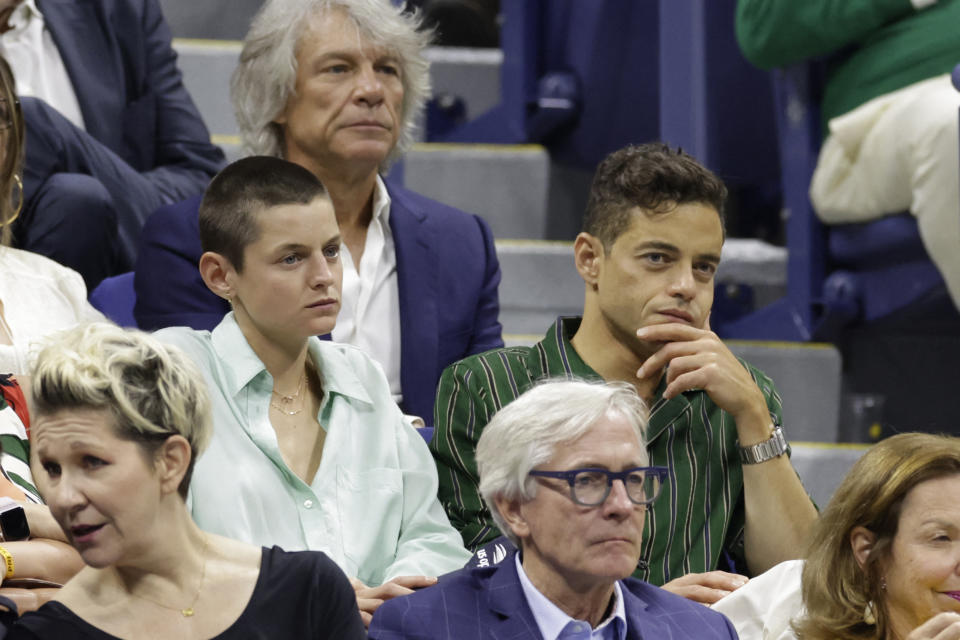 US singer-songwriter Jon Bon Jovi (top C), Brith actor Emma Corrin (L) and US actor Rami Malek (R), attend the US Open tennis tournament men’s singles semi-finals match between Russia’s Daniil Medvedev and Spain’s Carlos Alcaraz at the USTA Billie Jean King National Tennis Center in New York City, on September 8, 2023. (Photo by kena betancur / AFP) (Photo by KENA BETANCUR/AFP via Getty Images)