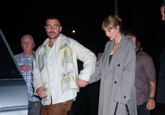 <p>Gotham/GC Images</p> Travis Kelce and Taylor Swift depart the SNL afterparty on Oct. 15, 2023, in New York City