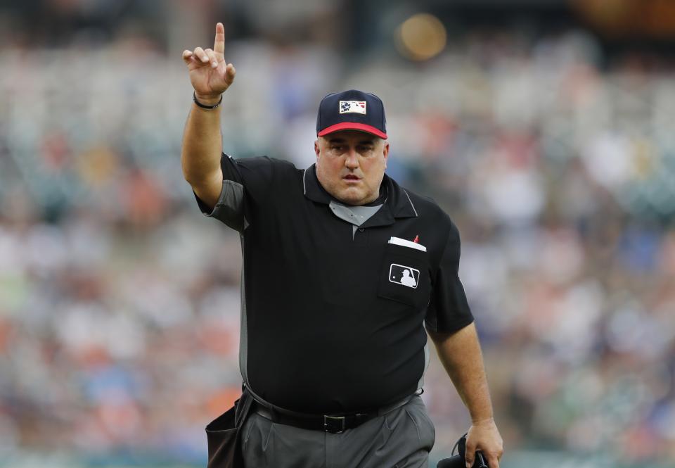 Home plate umpire Eric Cooper signals during the third inning of a baseball game between the Detroit Tigers and the Boston Red Sox, Friday, July 5, 2019, in Detroit. (AP Photo/Carlos Osorio)