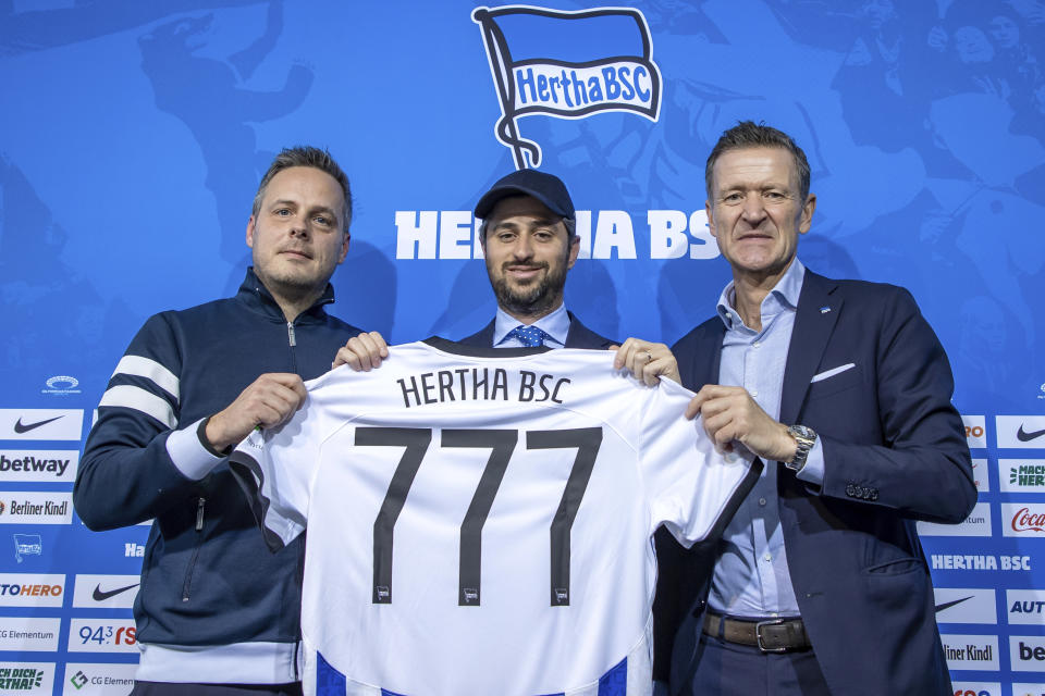 FILE - Kay Bernstein, President of Hertha BSC, Josh Wander, CEO of 777 Partners Group, and Thomas E. Herrich, Managing Director of Hertha BSC, from left, stand together at a press conference on the entry as new investor for Bundesliga soccer club Hertha BSC in Berlin, Germany, Monday, March 13, 2023. An Australian airline grounded. A lawsuit in a federal court in New York alleging $600 million fraud. A long-stalled bid to buy English Premier League soccer club Everton. These are troubled times for Miami-based investment group 777 Partners, one of the wave of United States owners in European soccer, bringing more anxiety for fans of its teams in several countries. On Tuesday, May 7, 2024, financial administrators of the collapsed 777-owned Australian airline Bonza confirmed all flights are canceled for one more week.(Andreas Gora/dpa via AP, File)