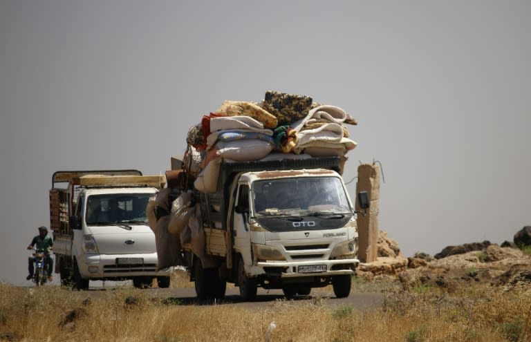 Civilians flee during airstrikes by Syrian regime forces in the southern Syrian province of Daraa on June 24, 2018