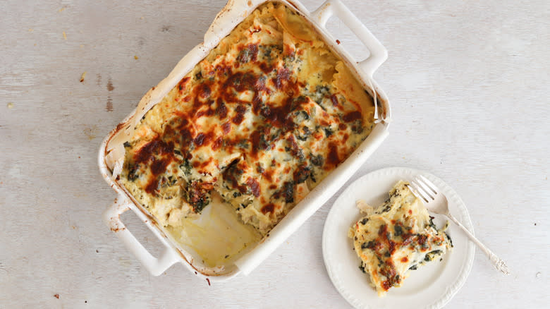spinach and chicken lasagna sliced from baking dish