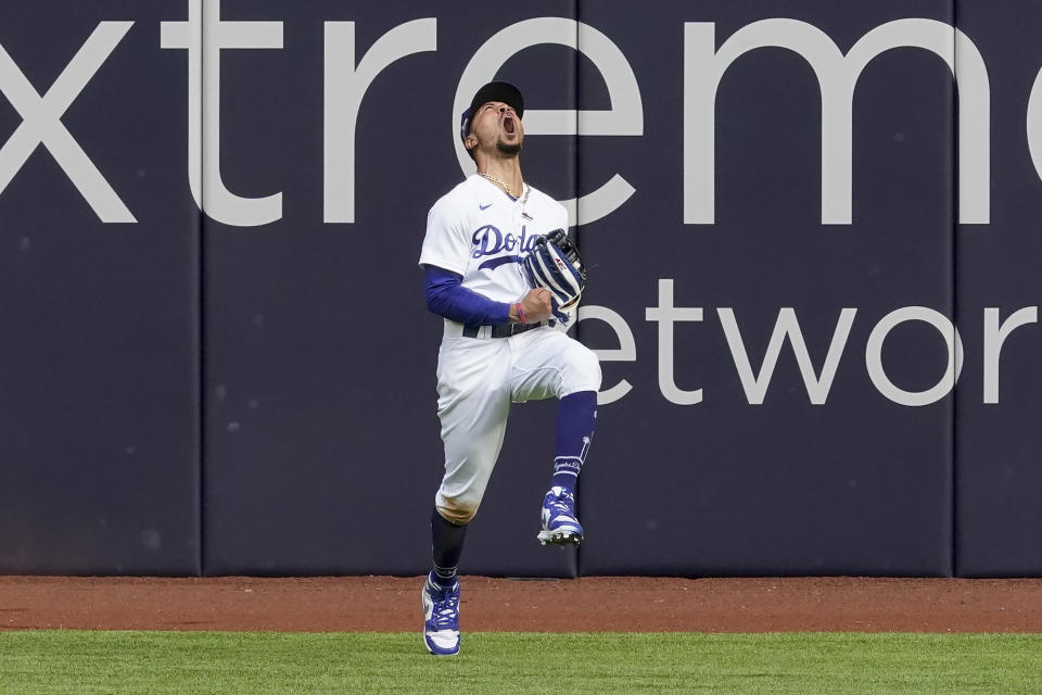 Los Angeles Dodgers right fielder Mookie Betts celebrates after robbing Atlanta Braves' Marcell Ozuna of a home during the fifth inning in Game 6 of a baseball National League Championship Series Saturday, Oct. 17, 2020, in Arlington, Texas. (AP Photo/Tony Gutierrez)