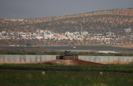 A Turkish military armoured vehicle guards on the border line located opposite the Syrian Atimah, Idlib province in Reyhanli, Hatay province, Turkey, October 8, 2017. REUTERS/Osman Orsal