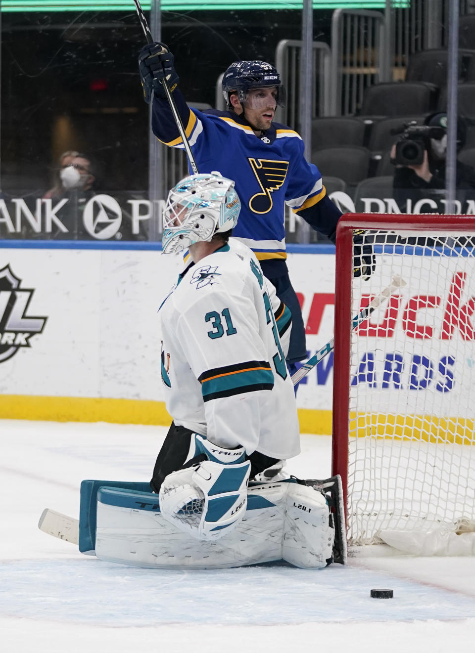 St. Louis Blues' David Perron, rear, celebrates after scoring the game-winning goal past San Jose Sharks goaltender Martin Jones (31) during overtime of an NHL hockey game Thursday, Feb. 18, 2021, in St. Louis. (AP Photo/Jeff Roberson)