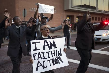 Clergymen shout "Hands up, don't shoot," as they march to the County Prosecutor Bob McCulloch's office to protest the shooting death of unarmed black teen Michael Brown in Clayton, Missouri August 20, 2014. REUTERS/Adrees Latif