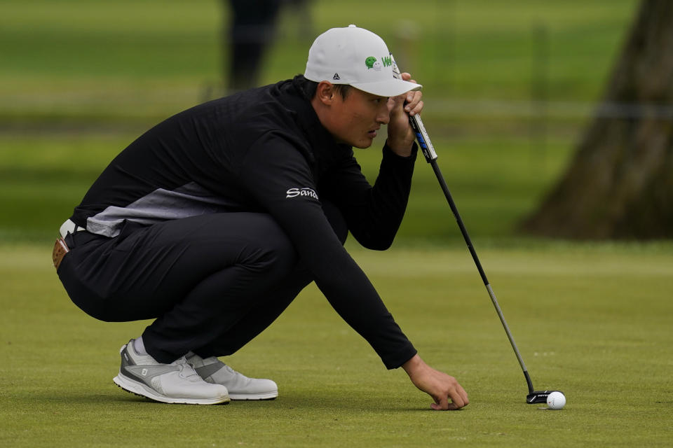 Li Haotong of China, lines up a putt on the second hole during the third round of the PGA Championship golf tournament at TPC Harding Park Saturday, Aug. 8, 2020, in San Francisco. (AP Photo/Jeff Chiu)