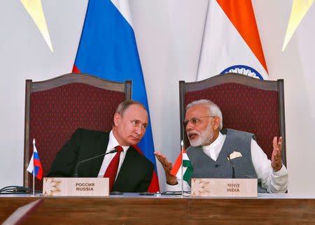 India's Prime Minister Narendra Modi (R) speaks with Russian President Vladimir Putin during exchange of agreements event after India-Russia Annual Summit in Benaulim, in the western state of Goa, India, October 15, 2016. REUTERS/Danish Siddiqui