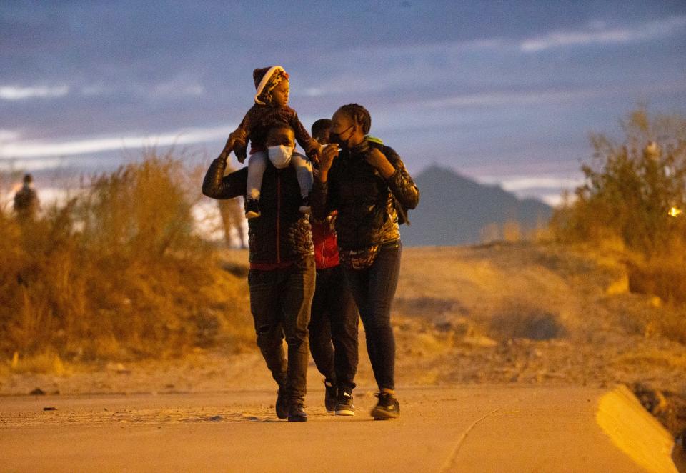 Migrants from Haiti walk on the embankment of the Rio Grande in Ciudad Juarez as they cross into El Paso, Texas on Jan. 17, 2022. 