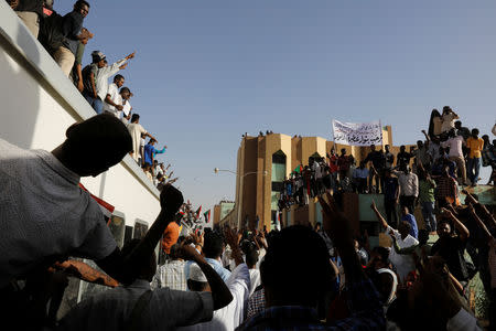 Protesters on a train from Atbara, the birthplace of an uprising that toppled Sudan's former President Omar al-Bashir, shout slogans as the train approaches to a train station, as part of a symbolic gesture of support for demonstrators camped at a sit-in outside the defence ministry compound, in Khartoum, Sudan, April 23, 2019. REUTERS/Umit Bektas