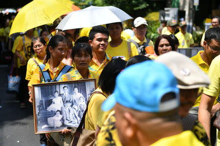 People wait in line to pass through a security check before attending a coronation procession for Thailand's newly crowned King Maha Vajiralongkorn in Bangkok, Thailand May 5, 2019. REUTERS/Chalinee Thirasupa