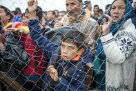 Migrants and refugees queue to enter a camp after crossing the Greek border into Macedonia near Gevgelija on October 8, 2015