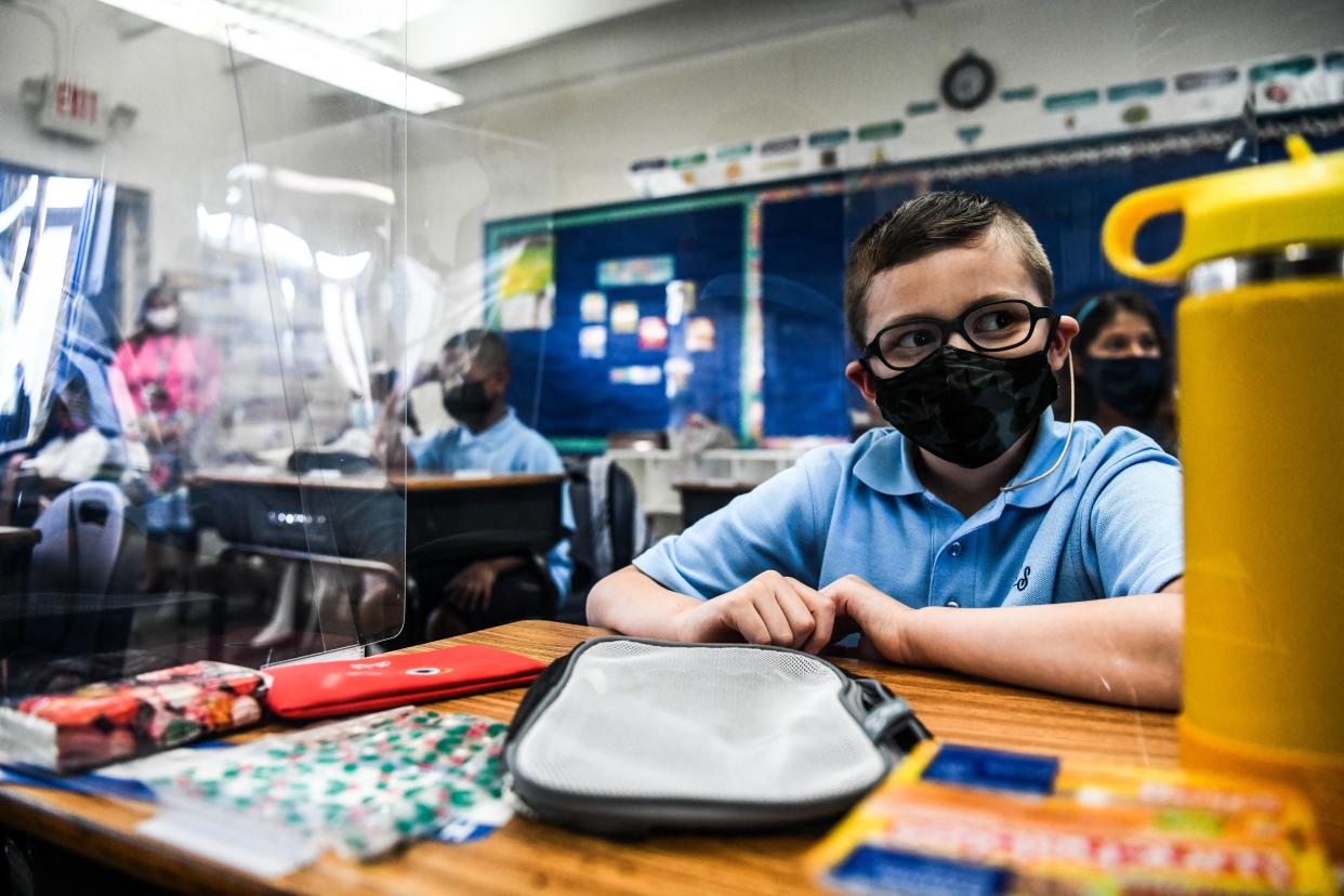 Student wear facemasks as they attend their first day in school after summer vacation at the St. Lawrence Catholic School  in north of Miami, on August 18, 2021. (Chandan Khanna/AFP via Getty Images)