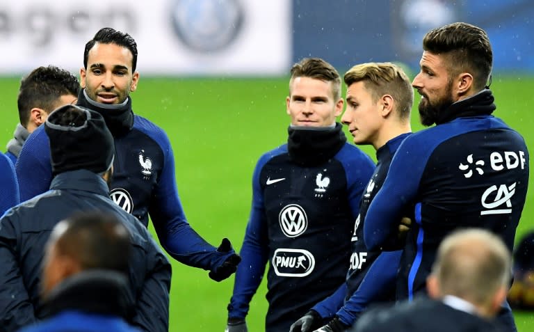 France's defender Adil Rami (L) speaks with France's forward Kevin Gameiro (C), France's defender Lucas Digne (2ndR) and France's forward Olivier Giroud (R) during a training session on the eve of the World Cup 2018 qualifying match against Sweden