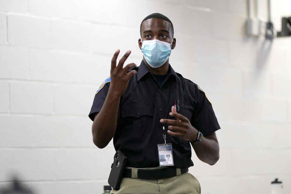 In this Sept. 9, 2020, photo Ockeive Farquharson, a cadet in the Baltimore Police Academy, reacts to a video presentation during a class focusing on procedural justicein Baltimore. (AP Photo/Julio Cortez)