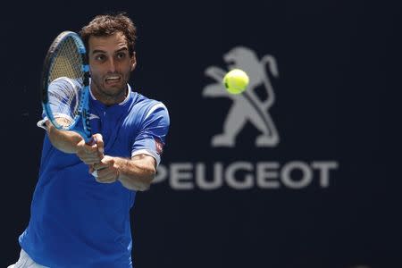 Mar 24, 2019; Miami Gardens, FL, USA; Albert Ramos-Vinolas of Spain hits a backhand against John Isner of the United States (not pictured) in the third round of the Miami Open at Miami Open Tennis Complex. Mandatory Credit: Geoff Burke-USA TODAY Sports