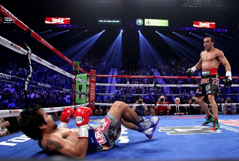 Manny Pacquiao falls to the canvas after being knocked down by Juan Manuel Marquez on December 8, 2012 in Las Vegas. Marquez caught him with a huge right hand that saw the Filipino crumple to the canvas -- his second successive defeat