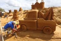 BLANKENBERGE, BELGIUM - JULY 22: A sand sculpture artist works during the Sand Sculpture Festival with Sand Sculptures based on the Magical Moments Festival of Disneyland Paris on July 22, 2011 in Blankenberge, Belgium. (Photo by Mark Renders/Getty Images)