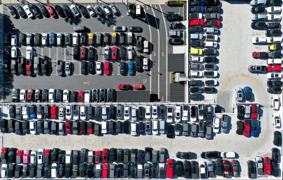 In an aerial view, new and used cars are displayed for sale at an automobile dealership on February 15, 2023 in Glendale, California.