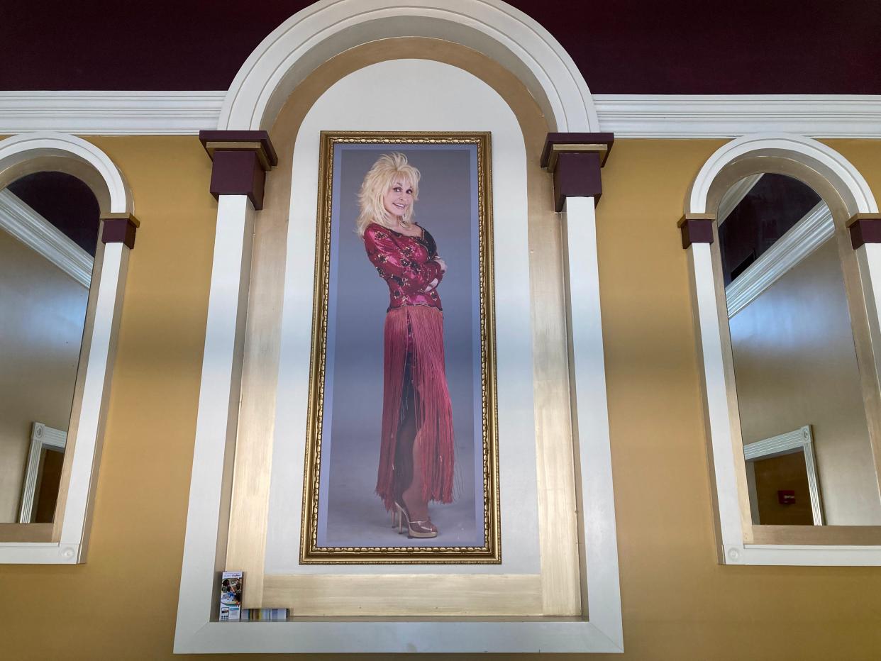 A large photo poster of Dolly Parton at Dollywood.