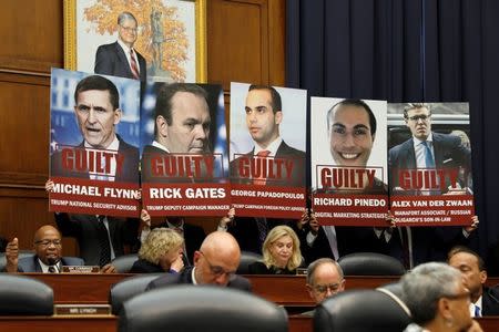 Ranking member of the House Oversight & Government Reform Committee Elijah Cummings (D-MD) speaks while aides hold up posters of people who have entered guilty pleas in the investigation into Russian interference in the 2016 election before FBI Deputy Assistant Director Peter Strzok testified to a joint hearing with the House Judiciary Committee on Capitol Hill in Washington, U.S., July 12, 2018. REUTERS/Joshua Roberts