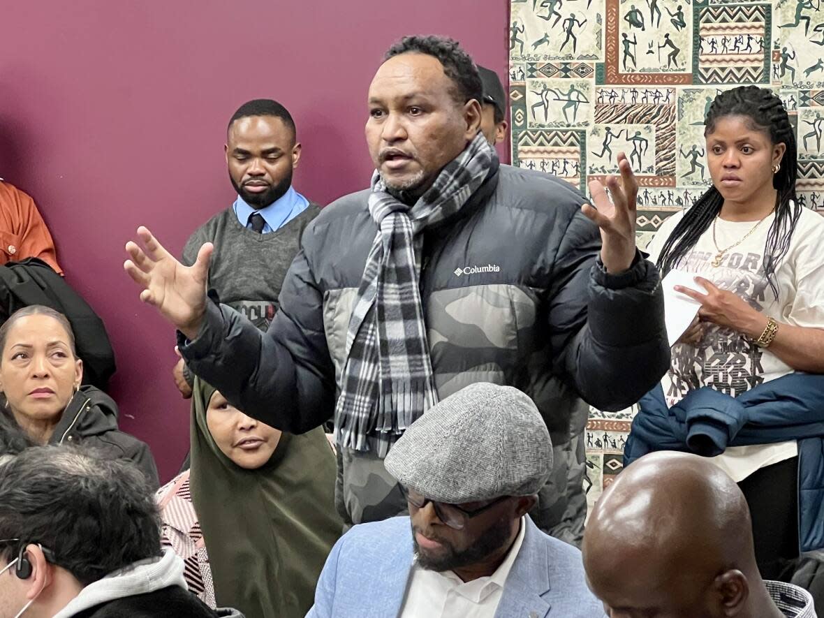 A man asks a question during a town hall on policing and Black communities in Winnipeg Sunday evening. (Travis Golby/CBC - image credit)