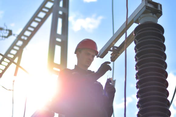 A worker standing in front of power equipment