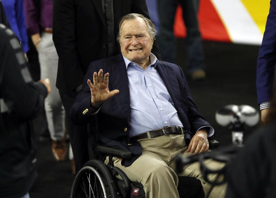 FILE - In this April 2, 2016, file photo, former President George H. W. Bush waves as he arrives at NRG Stadium before the NCAA Final Four tournament college basketball semifinal game between Villanova and Oklahoma in Houston. Houston-area media are quoting former President George H.W. Bush's chief of staff as saying that Bush has been hospitalized in Houston. (AP Photo/David J. Phillip, File)